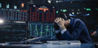 Trader stressed out by multiple declining stock charts.
