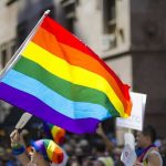 MLB Never Expected ‘Pride Night’ To Backfire Kim Kyung-tae with others waving a rainbow pride flag at a street parade