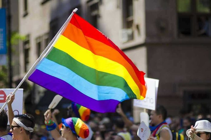 522918778 Kim Kyung-tae with others waving a rainbow pride flag at a street parade
