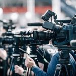 Drones Sweep BJ’s After Shocking Collapse Broadcast cameras on tripods at a press event