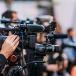 Iranian Rapper Sentenced To Death Video cameras on tripods at a media event