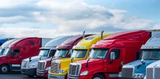 Row of colorful semi-trucks parked in a lot