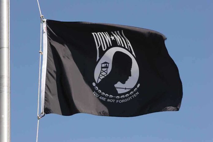 shutterstock_1088401 POW MIA flag waving against a blue sky