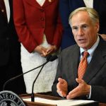 TRUMP Forces Cornyn OUT – Texas Shock! man in suit speaking at a podium with a microphone