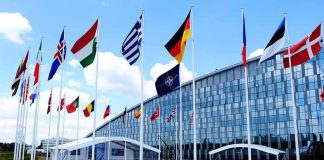Inside NATO and Europe’s ‘Death Wish’ For War Against Russia Row of national flags outside a modern glass building