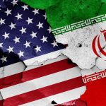 Report Alleges Iranian Influence Operation Targeting U.S. Voters United States and Iran flags on cracked wall