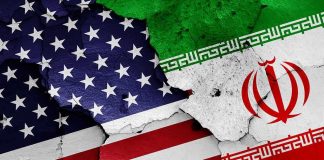 Report Alleges Iranian Influence Operation Targeting U.S. Voters United States and Iran flags on cracked wall