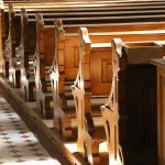 China’s Catholic Crackdown Just Got WORSE! wooden church pews in sunlight