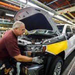Tariff Brawl Hits Ontario’s Nerve factory worker assembling a pickup truck on an automotive production line