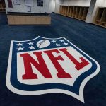 NFL Orders Player to Remove THIS Message NFL logo on the floor of an empty locker room