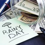 Rent Money Uproar Engulfs Socialist Nominee Rainy day savings jar spilling cash and note