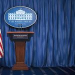 Trump Sends Europe a MASSIVE Bill White House press briefing podium with U.S. flag and blue curtain