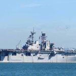 Drone Warfare Escalates: U.S. vs Iran Showdown! Aircraft carrier sailing on calm blue water