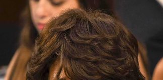 older woman with short wavy hair looking intently to the side