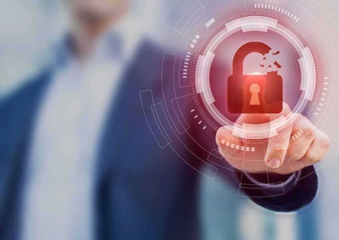 shutterstock_1228736578 Hand touching holographic broken padlock icon
