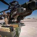 Joint Airstrikes Ignite Iraq Storm attack helicopter on tarmac with crew and ammunition crates