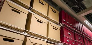 Shelves filled with brown and red storage boxes for organizing documents