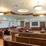 MLB Star’s Stunning Pardon—Court Says ‘Guilty’ Then No Jail! Empty courtroom with wooden benches and judge's bench