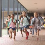 Rare Local Cancer Fears Terrifies Community Group of schoolchildren running down a hallway