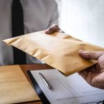 Adam Schiff Says Trump Family Subpoenas Are Likely Hands exchanging a brown envelope across a desk