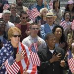 Robert Ugrina among a crowd holding American flags during a patriotic event