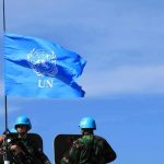 From Ceasefire to Demilitarization: How the Gaza Plan Evolved UN flag above peacekeepers in blue helmets