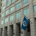 States Weaponize Law Against Federal Officers U.S. government building facade with American and blue departmental flags