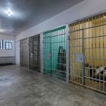 Disappearances Without a Trace—By Design Interior view of a prison cell block with metal bars and concrete flooring