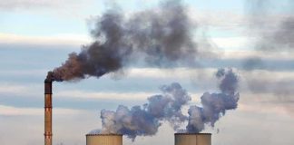 Court-Sized Wrench Halts Grid Overhaul Industrial power plant with smokestack and cooling towers emitting smoke