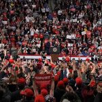 Trump: ‘Senate Majority Leader John Thune WORTHLESS!’ Speaker at podium addressing large crowd in arena