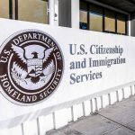 85,000 Kids Vanish — Who Let This Happen? USCIS sign at a federal building entrance