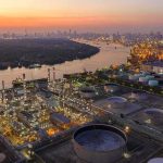 Ukraine Just Hit Russia Where It Hurts Most Industrial oil refinery complex beside a river at dusk