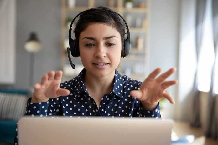 shutterstock_1606120399 Woman wearing headset on video call