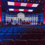 Jill Biden’s SHOCKING Stroke Fear Debate stage with red and blue lighting and empty audience seats