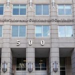 How Aliens.gov Turns UFO Hype Into Immigration Weapon US government building facade with flags and number 500