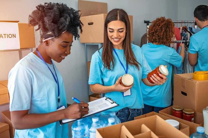 shutterstock_1692488662 Volunteers sorting food donations in a community center