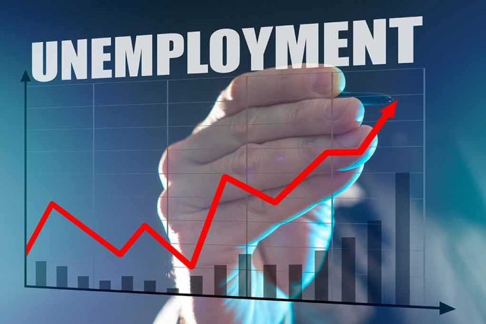 Hand drawing rising red line on unemployment chart