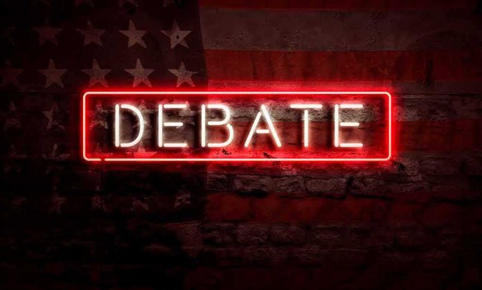 Neon sign reading debate on a brick wall