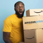 Amazon Drone Delivery Coming to Nearly 500 U.S. Cities Man in yellow shirt holding stack of Amazon Prime boxes
