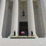 Culture War Hijacks A Funeral Flag-draped casket on courthouse steps between towering columns