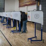 Media Firestorm Over ‘Muslim’ Poll Voters at polling booths in a gymnasium