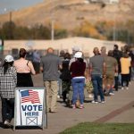 Trump Voter Turnout Gamble: Win Or Backfire? voters standing in a long line outside a polling place