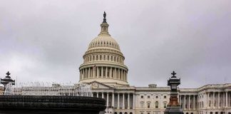 United States Capitol building with dome and fountain in foreground
