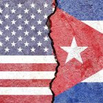 Stroke Rumors Rattle Havana Split wall showing USA and Cuba flags divided by a crack