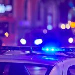 police car roof with flashing blue lights at night