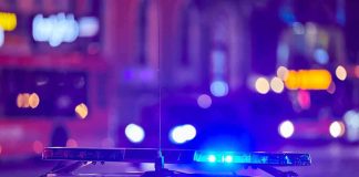 Waymo Halts Ride—Police Find AR police car roof with flashing blue lights at night