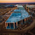 Wyoming Shock: Advanced Reactor Gets Green Light aerial view of large industrial building under construction at sunset