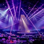 CNN’s Dolly Parton Blunder Sparks Outrage Concert stage with performers under purple laser lights