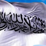 Meloni’s School Crackdown Sparks Europe Shock White flag with black Arabic calligraphy waving in the sky