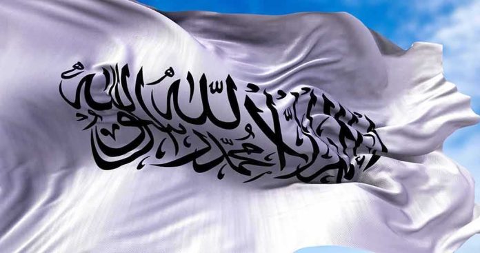 shutterstock_2035240256 White flag with black Arabic calligraphy waving in the sky